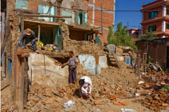 People Salvaging Materials from Eathquake Damaged House